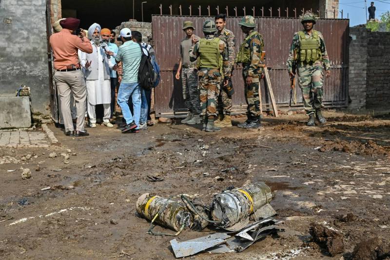Indian Army personnel stand next to explosives, carried by a drone, after it was intercepted by an Indian air defense system on the outskirts of Amritsar, in northwestern India, on May 10.