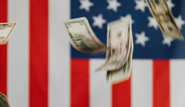 Photo of dollars behind American flag