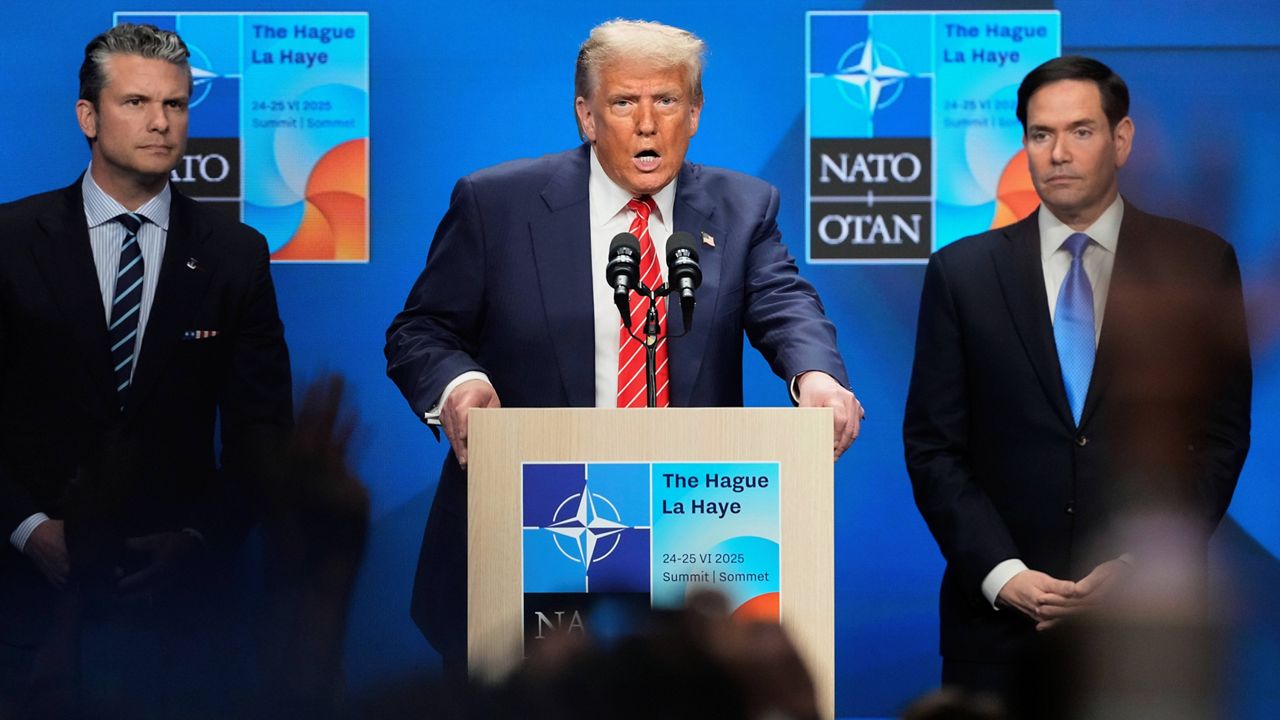 President Donald Trump speaks standing between Secretary of State Marco Rubio, right, and Defense Secretary Pete Hegseth during a press conference after the plenary session at the NATO summit in The Hague, Netherlands, Wednesday, June 25, 2025. (AP Photo/Markus Schreiber)