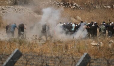 Syrian Druze run away from tear gas fired by Israeli soldiers as they protest on the Syrian side of the border with Israel, seen from Majdal Shams in the Israeli-controlled Golan Heights, Wednesday, July 16, 2025, amid the ongoing clashes between Syrian government forces and Druze armed groups in the southern Syrian city of Sweida. (AP Photo/Leo Correa)