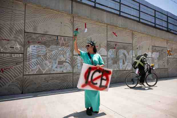 Kimi Carpenter, of West LA, protests the detention of undocumented...