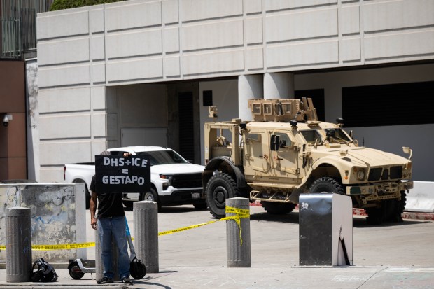 An activist protests the detention of undocumented residents and the...