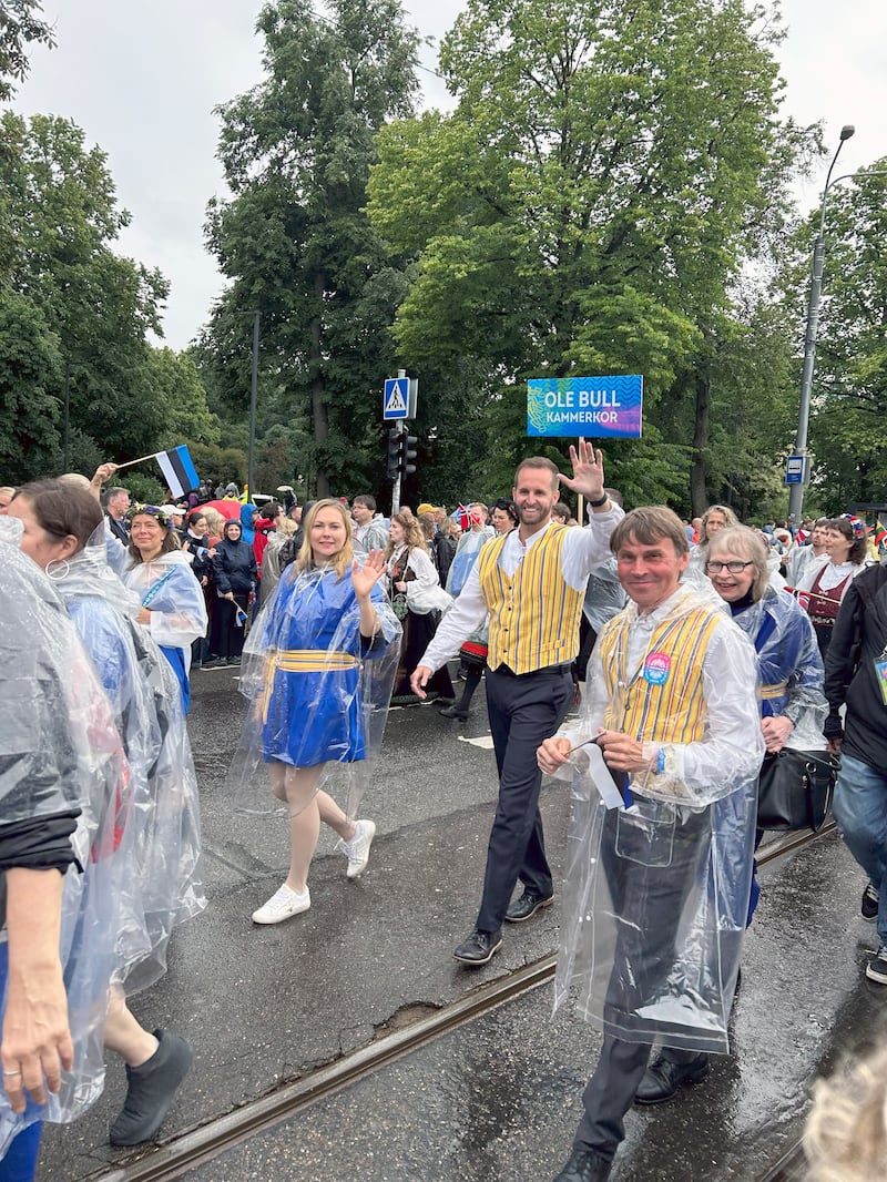 Lance McGavin walks in the Estonian Song Festival parade with other choir members from the New York Estonian Mixed Choir in Tallinn, Estonia, July 5, 2025.
