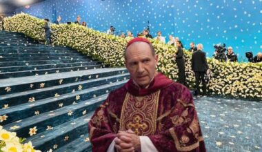 Actor Ralph Fiennes in cardinal garb photoshopped onto the Met Gala carpet