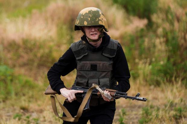 A Ukrainian 3rd Assault Brigade recruit runs to take a...
