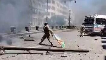 A suspected jihadist fighter seen throwing a Druze flag into a street fire in Sweida לוחם בדואי שורף דגל דרוזי של דרוזים ב א-סווידא סווידא סוריה