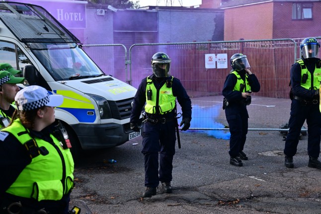Police gathered outside the Bell Hotel which is used to house asylum seekers in Epping