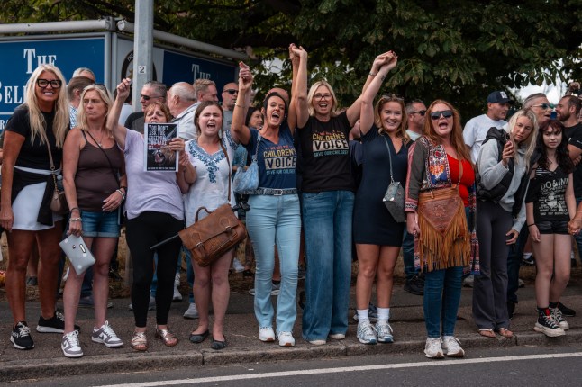 EPPING, ENGLAND - JULY 20: Women demonstrate outside the Bell Hotel on July 20, 2025 in Epping, England. People have been protesting at the use of the Bell Hotel in Epping for housing migrants following the arrest of an asylum seeker on suspicion of alleged sexual assaults in the town. An Ethiopian national was charged with three sexual offences, harassment and inciting a girl to engage in sexual activity. The Home Office has said it had 