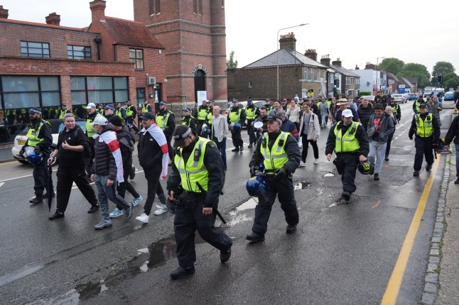 Police walk next to protesters outside in Epping, Essex, where asylum seekers are believed to be housed at the former Bell Hotel, where there have been a number of demonstrations, after police charged 38-year-old asylum seeker Hadush Gerberslasie Kebatu with sexual assault following an incident where he is alleged to have attempted to kiss a 14-year-old girl. Picture date: Thursday July 24, 2025. PA Photo. The police and Government are ready to respond if violent protests over the asylum system spread following events in Epping, a Cabinet minister said. Business Secretary Jonathan Reynolds said he could understand people's frustrations at hotels being used to house asylum seekers but insisted that had come down from around 400 hotels to "just over 200". Photo credit should read: Lucy North/PA Wire