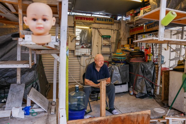 Western Wear owner Calvin Blocker sits in the empty booth...