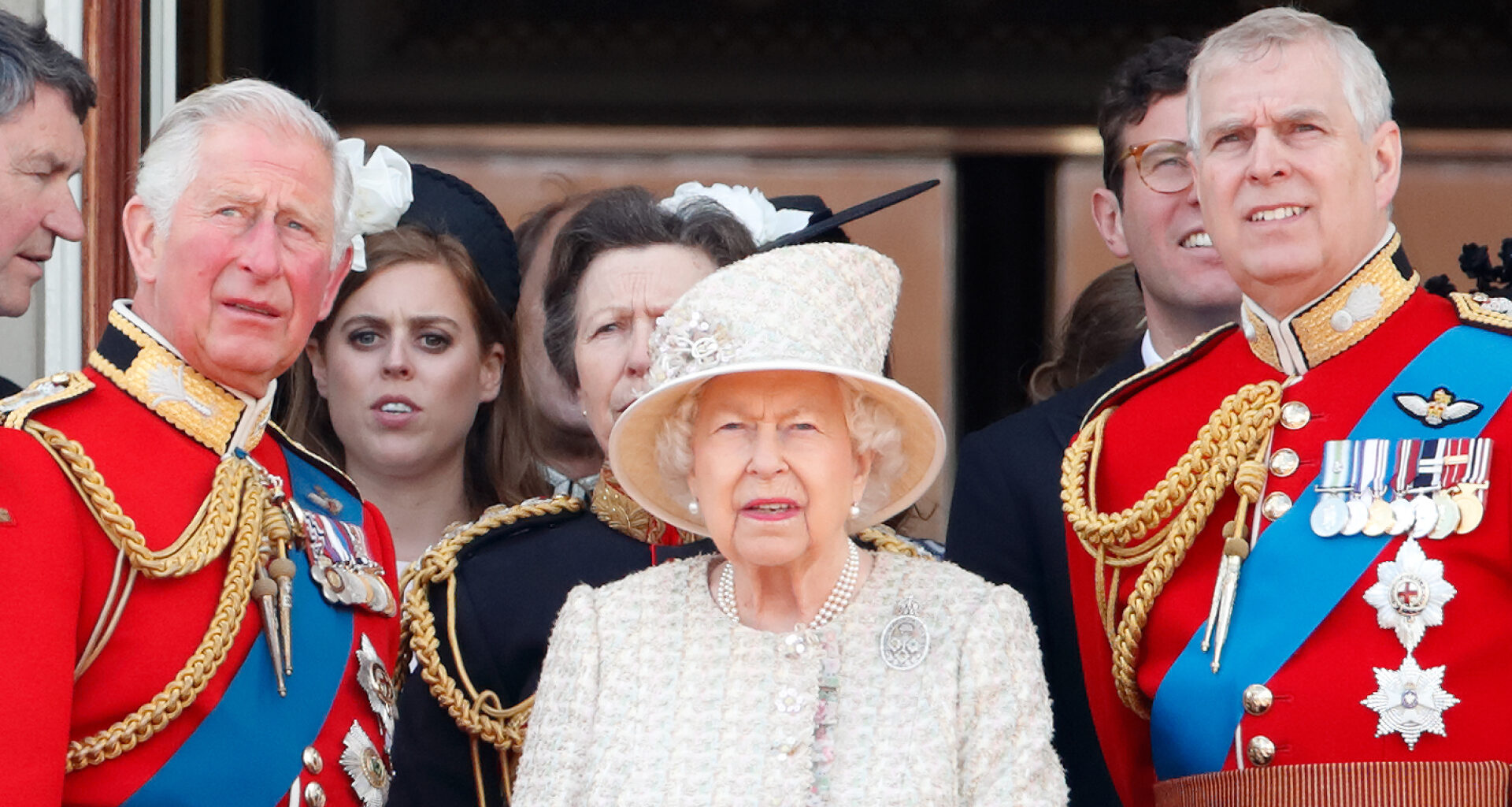 King Charles and Prince Andrew wear red military uniforms as they stand on the Buckingham Palace balcony with Queen Elizabeth II