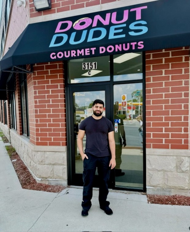 Khader Zahdan stands in front of the donut shop he opened with his brother, Mohammed Zahdan, along Kedzie Avenue in Chicago's Mt. Greenwood neighborhood. (Bridget Forbes)