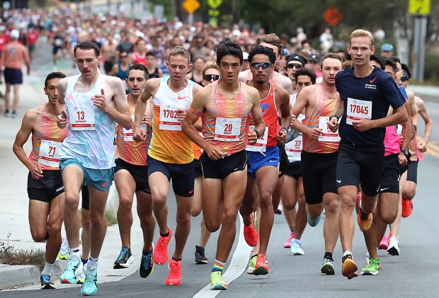 Men's champion Arturs Medveds, right, bides his time on Portola...