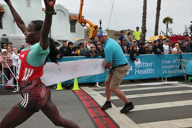 Women's winner Atsede Tesema breaks the tape at the Capitola...