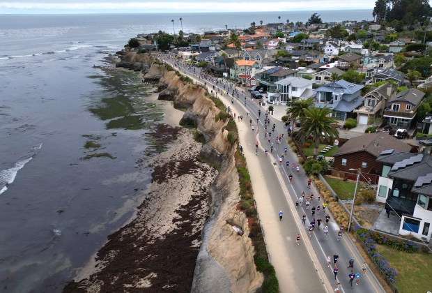 Runners stride along East Cliff Drive in Pleasure Point during...