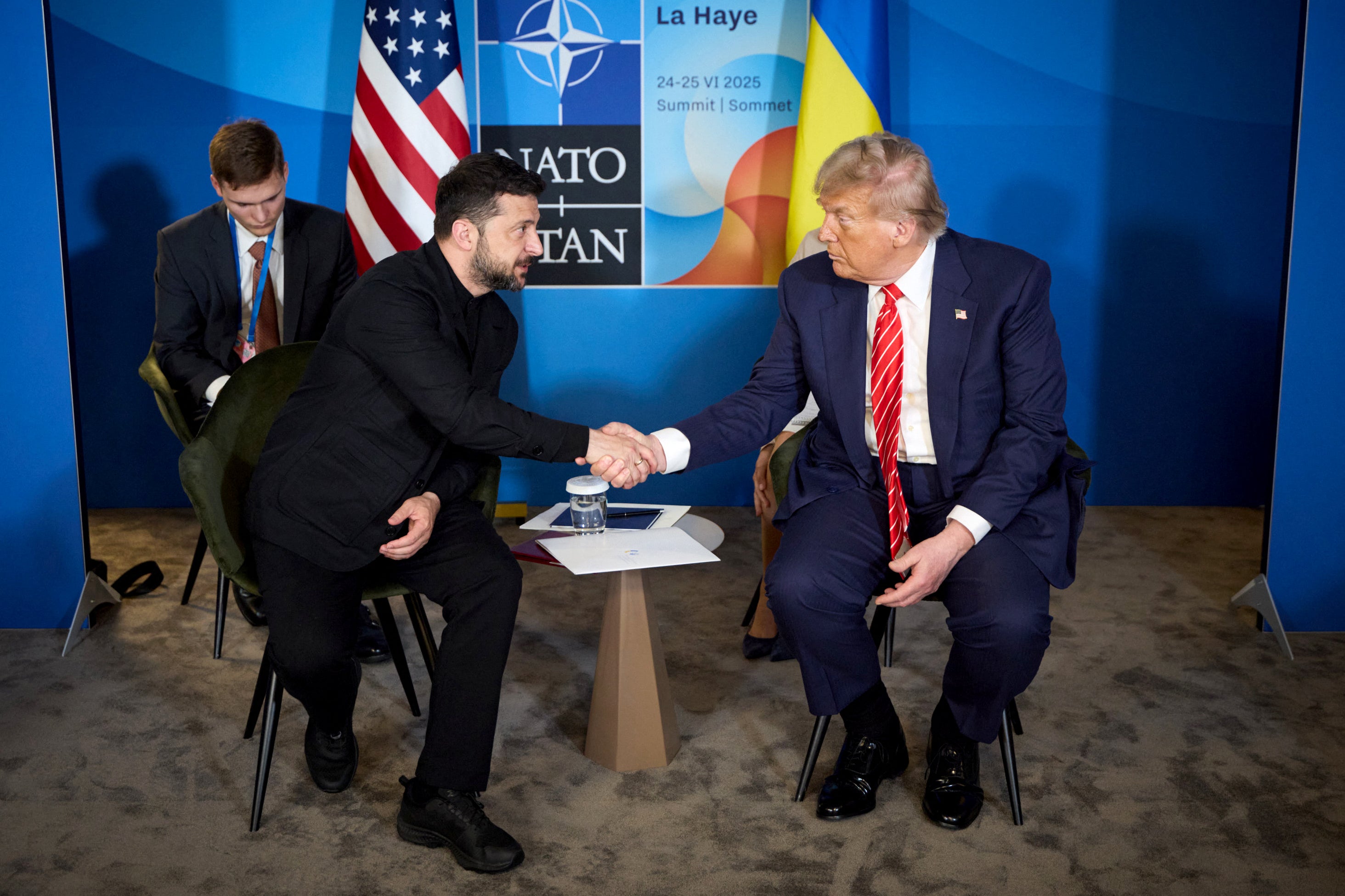 File: Ukraine's President Volodymyr Zelensky (L) shakes hands with US President Donald Trump (R)