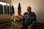 Haitham Nasralla sits on his bed at the fire house.