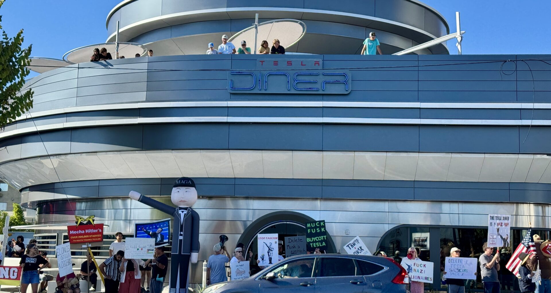 ‘A Monument to Corporate Greed:’ Elon Musk’s Tesla Diner Fuels Protests In L.A.