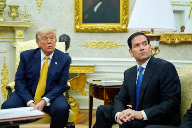 President Donald Trump and Secretary of State Marco Rubio listen...