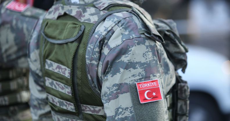 The side of a person in Turkish military fatigues.