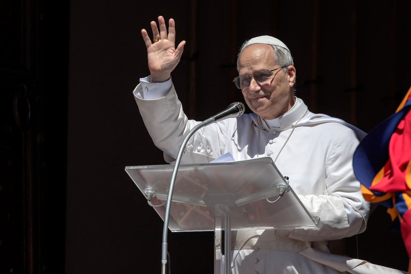 Pope Leo XIV waves to the crowd during the Angelus prayer from the Apostolic Palace of Castel Gandolfo, where the pontiff is spending his summer vacation.