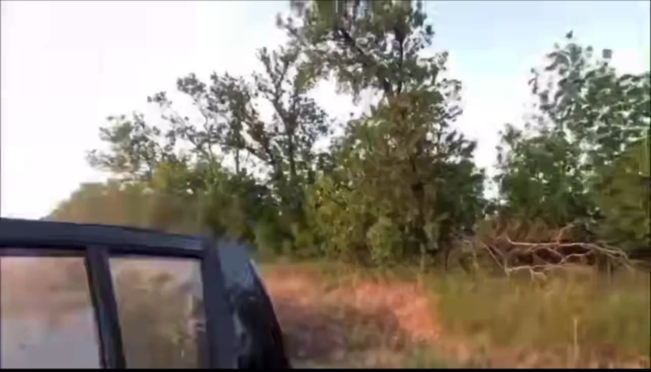 Ukrainian soldiers escaping their vehicle seconds before an FPV drone impacts it