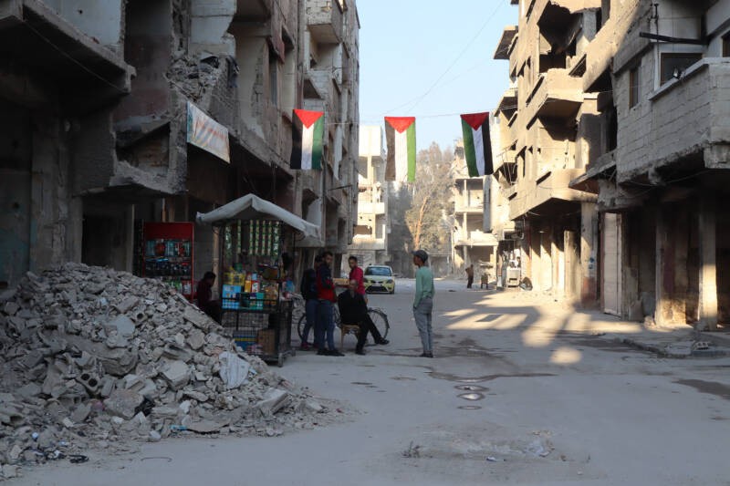 A small shop sells basic food items amid the rubble of damaged buildings in the Yarmouk camp in southern Damascus, 30/4/2025 (Natacha Danon/Syria Direct)