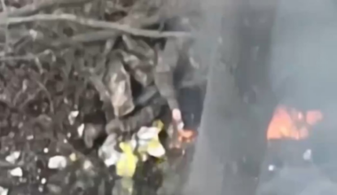 Russian lights a cigarette using his burning comrad as a lighter