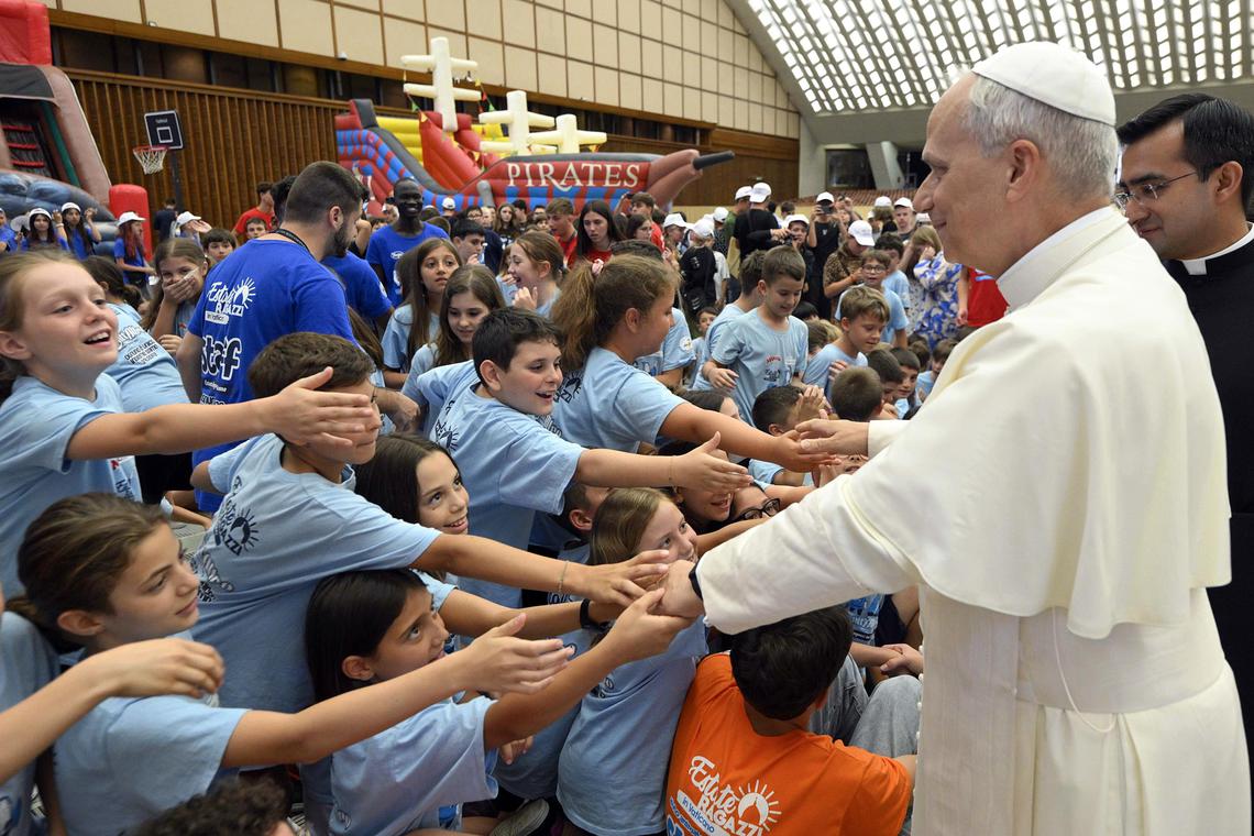 epa12212623 A handout picture provided by the Vatican Media shows Pope Leo XIV (2-R) greeting children during an audience with children and young people participating in the 'Estate Ragazzi in Vaticano' summer camp in the Paul VI Hall, Vatican City, 03 July 2025. Several hundred children, including Ukrainian, and young people gathered in the Paul VI Hall for the Vatican summer camp.  EPA/VATICAN MEDIA HANDOUT HANDOUT EDITORIAL USE ONLY/NO SALES