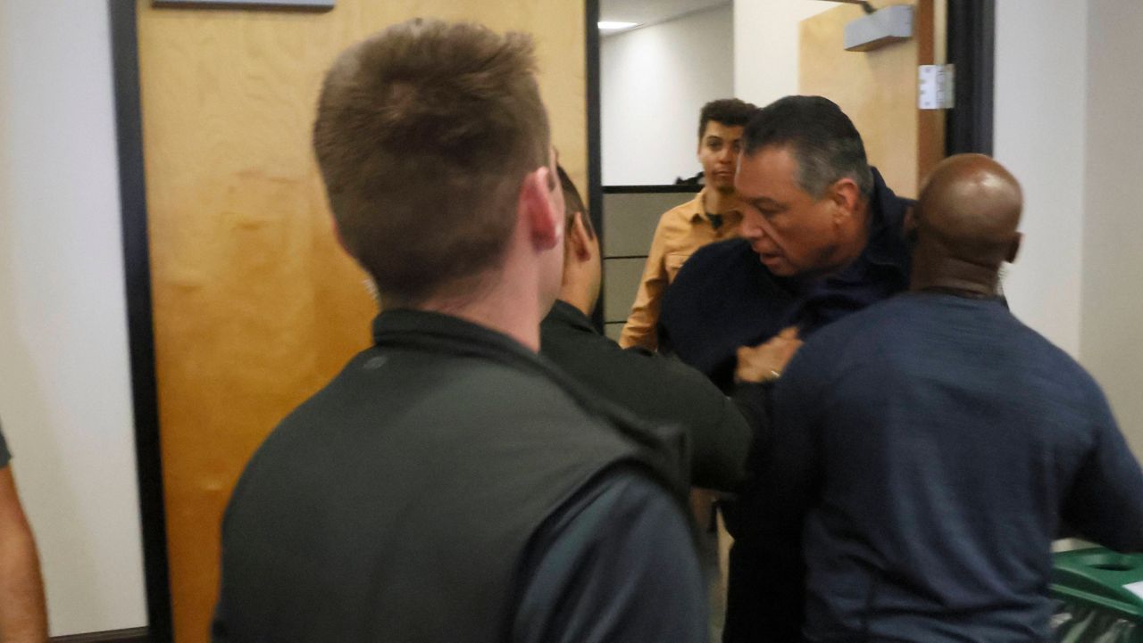 U.S. Sen. Alex Padilla is pushed out of the room as Homeland Security Secretary Kristi Noem holds a news conference regarding the recent protests in Los Angeles on Thursday, June 12, 2025. (AP Photo/Etienne Laurent, file)