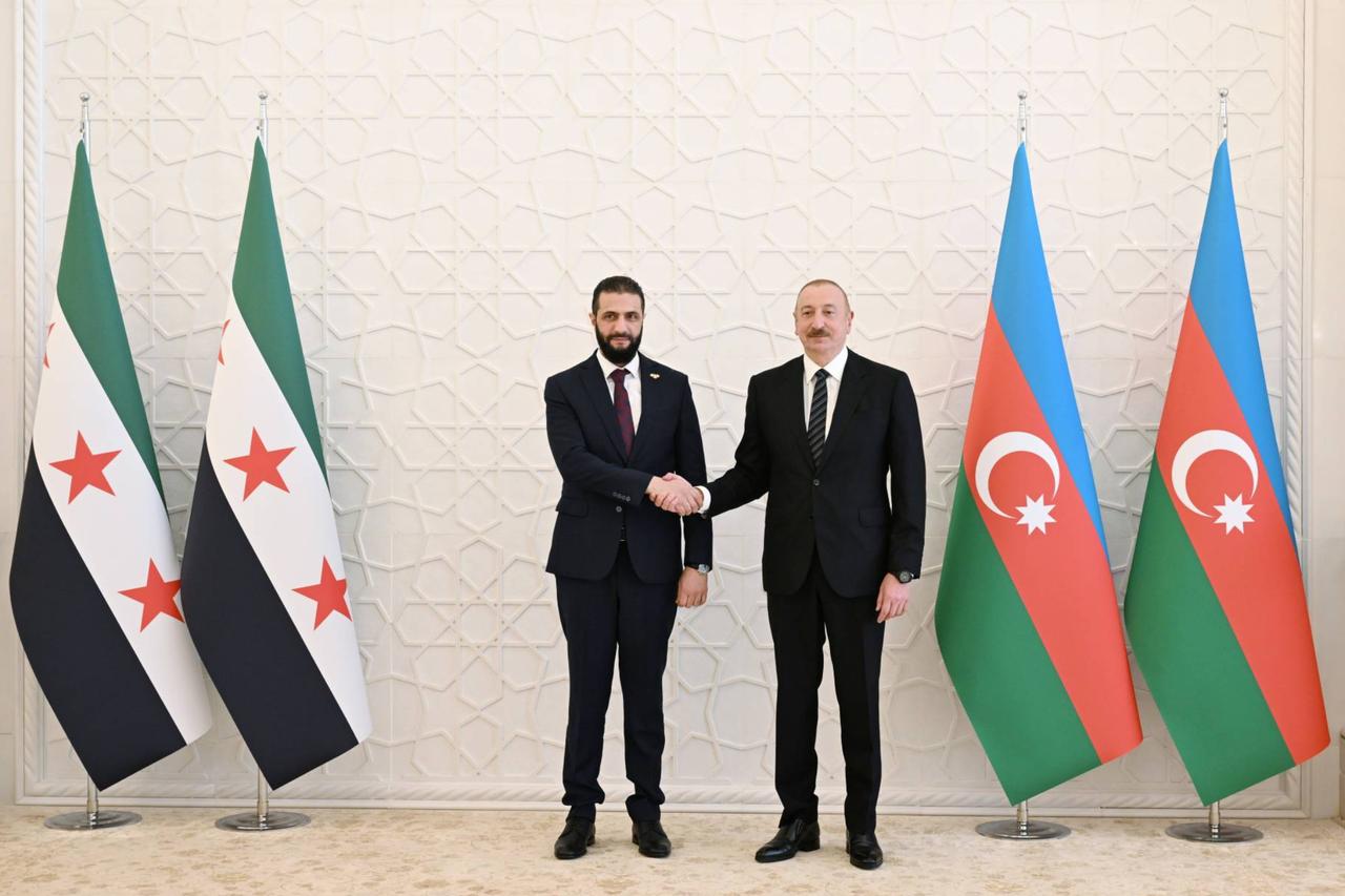 Syrian President Ahmed al-Sharaa (L) meets with Azerbaijans President Ilham Aliyev (R) in Azerbaijan capital Baku during an official visit on July 12, 2025. (Azerbaijani Presidency / Handout)