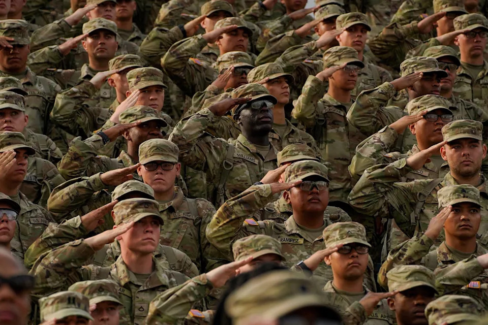 Members of the U.S. military salute during a ceremony to redesignate Fort Benning as Fort Moore, at Doughboy Stadium in Columbus, Georgia, on May 11, 2023.