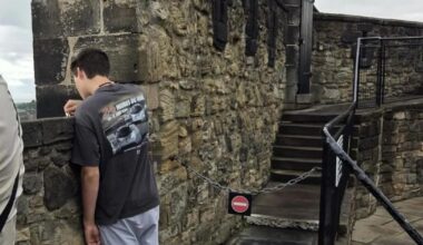 Scratching "Whatever" into the wall of Edinburgh Castle