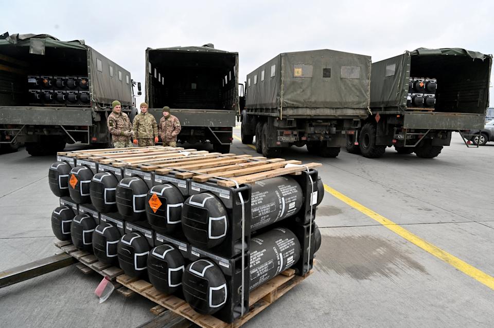 Sergei Supinsky/AFP via Getty Images - PHOTO: Ukrainian servicemen are at work to receive the delivery of FGM-148 Javelins, American man-portable anti-tank missile provided by US to Ukraine as part of a military support, at Kyiv's airport Boryspil, Feb. 11, 2022.