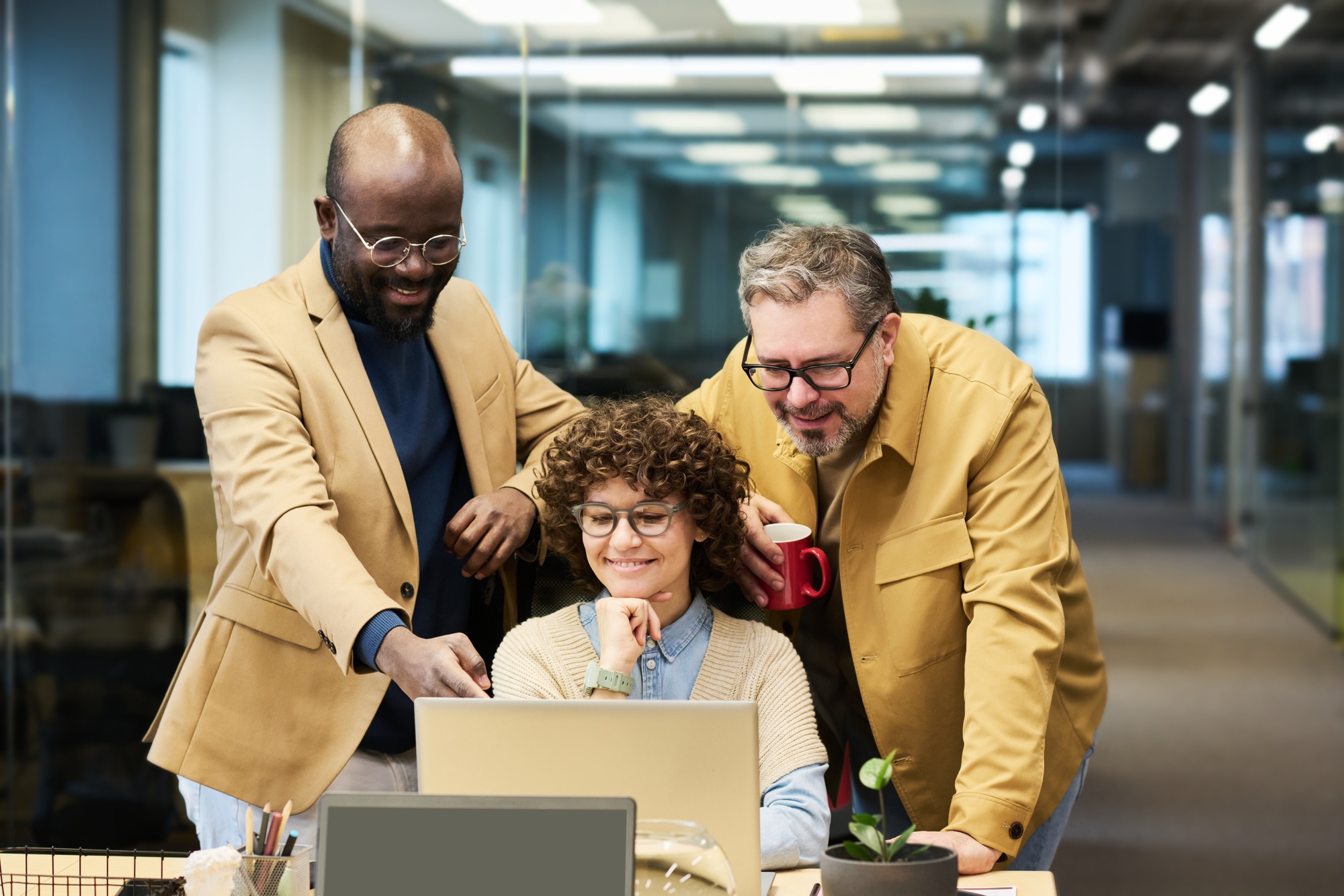 Confident African American businessman explaining graphic data to colleagues