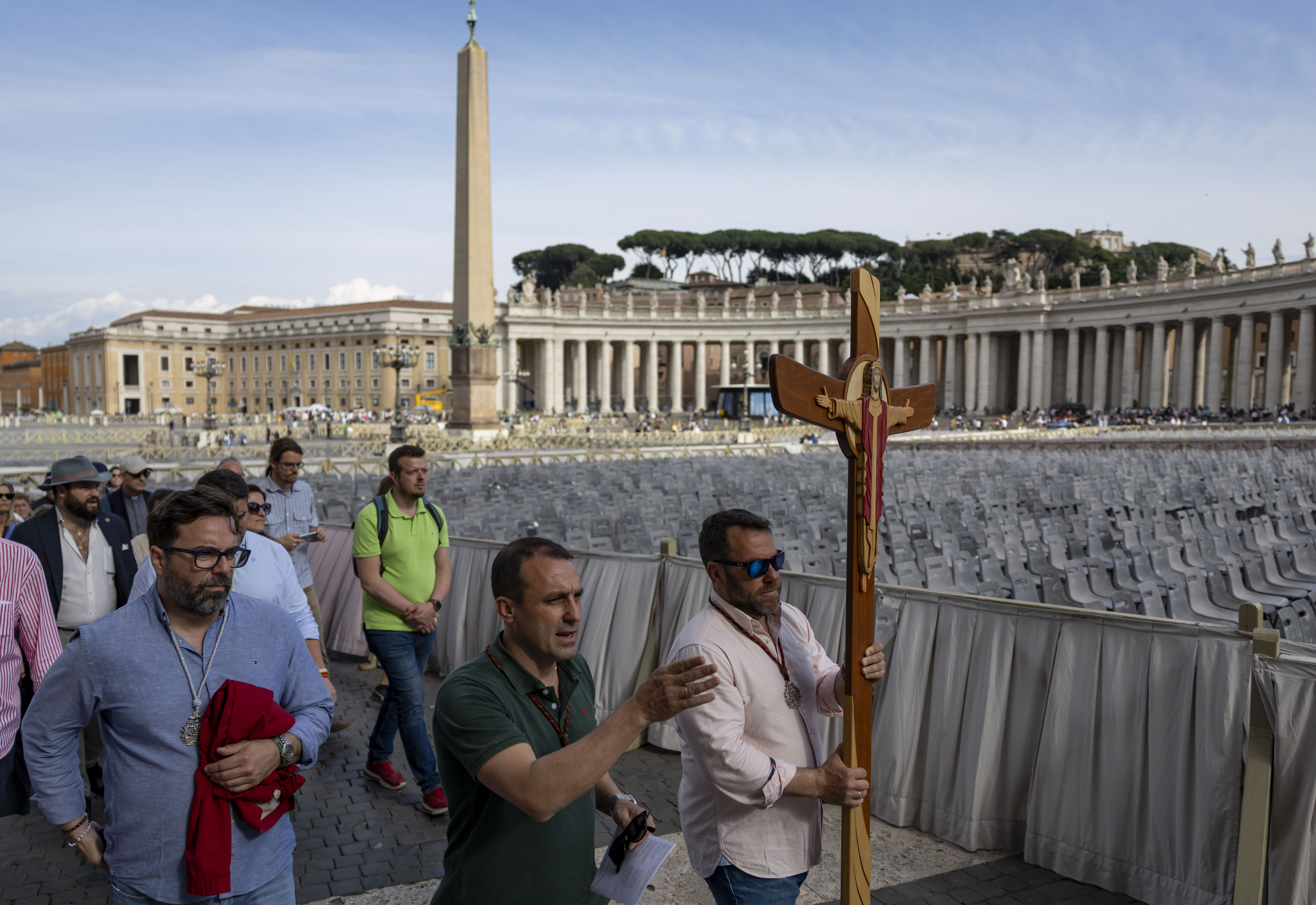 A group carries a cross as part of the Jubilee through St. Peter's Square on May 15, 2025, before the installation of Pope Leo XIV at the Vatican. (Brian Cassella/Chicago Tribune)