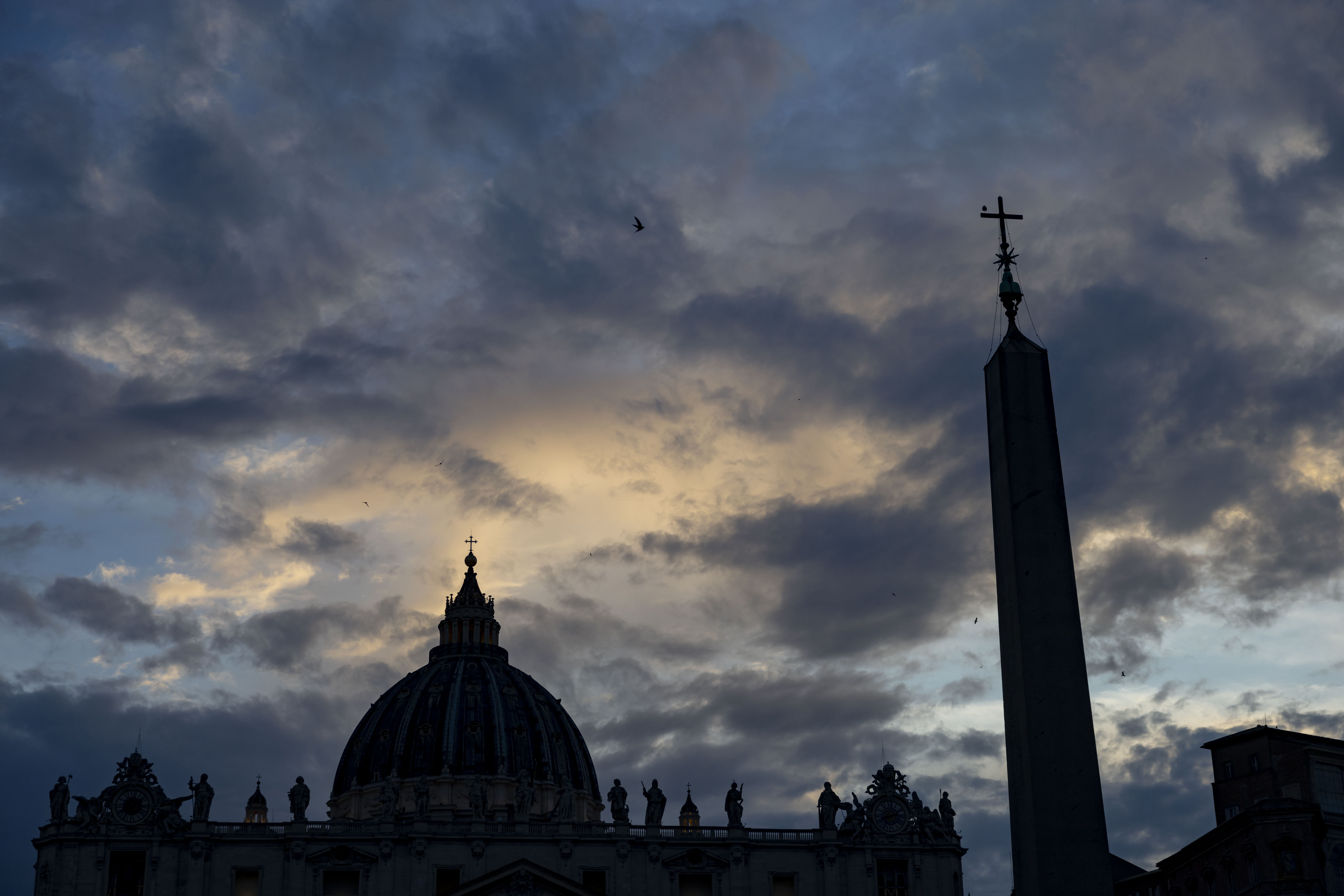 The sun sets on St. Peter's Basilica on May 15, 2025, before the installation of Pope Leo XIV at the Vatican. (Brian Cassella/Chicago Tribune)