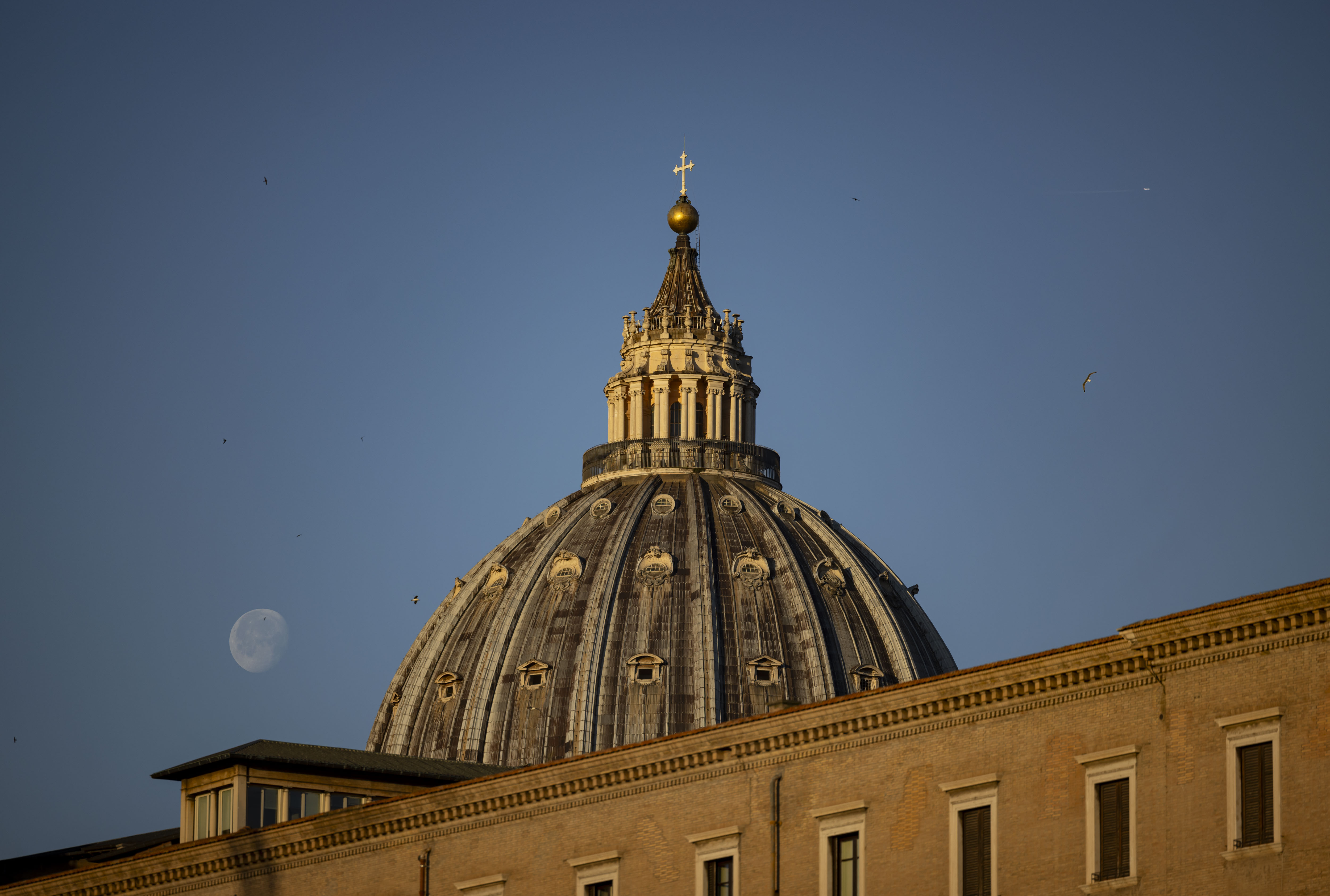 The moon next to St. Peter's Basilica on May 16, 2025, before the installation of Pope Leo XIV at the Vatican. (Brian Cassella/Chicago Tribune)