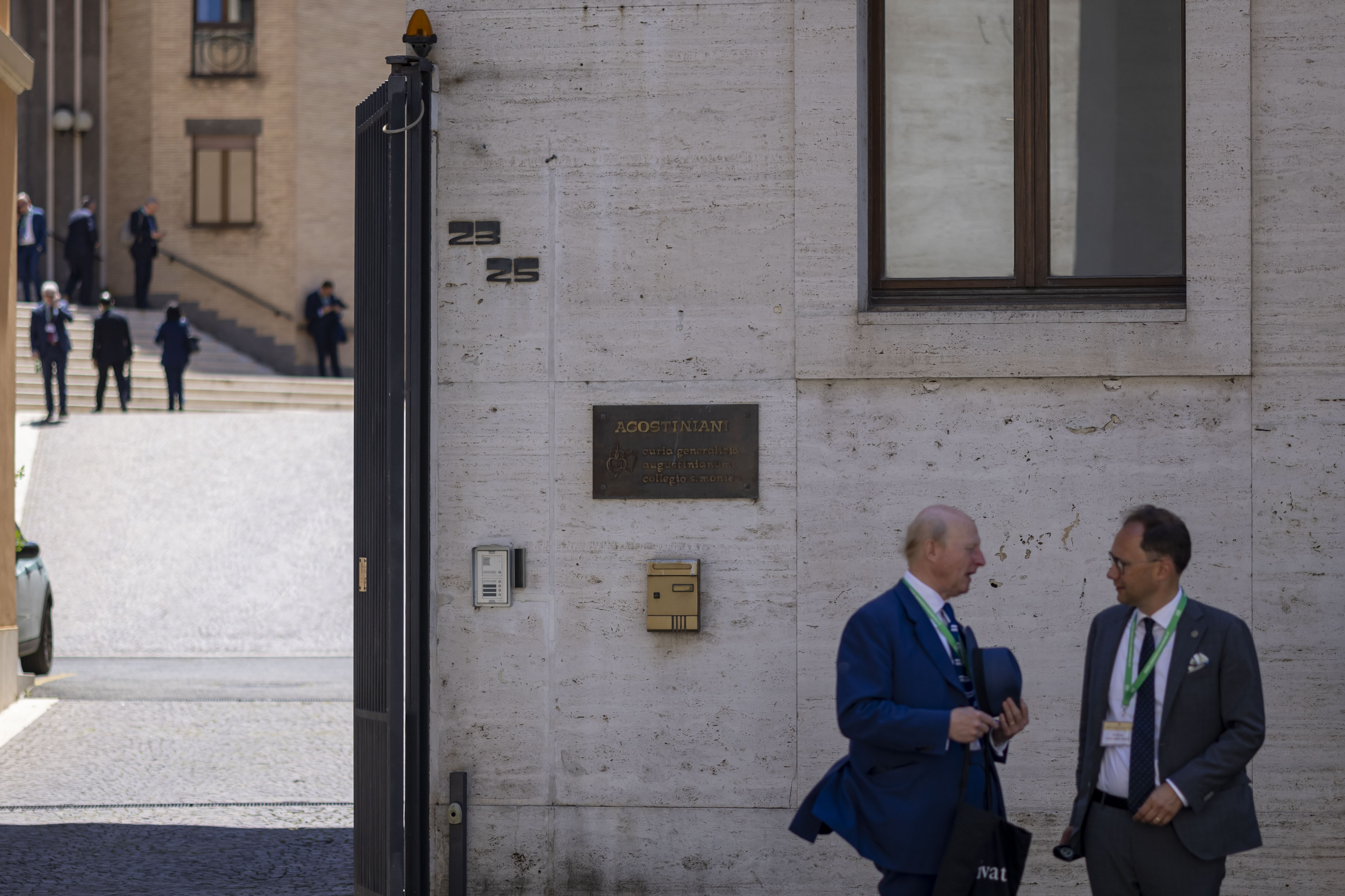 People talk outside the Aug.inian General Casio next to St. Peter's Square on Friday, May 16, 2025, before the installation of Pope Leo XIV at the Vatican. (Brian Cassella/Chicago Tribune)