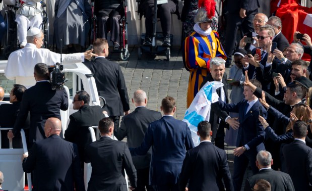 Pope Leo XIV acknowledges a Chicago flag in the crowd as he arrives for his installation Mass in St. Peter's Square on Sunday, May 18, 2025, at the Vatican. (Brian Cassella/Chicago Tribune)