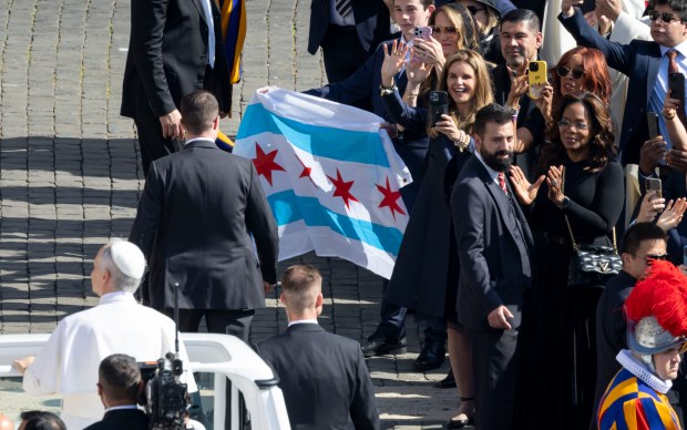 Oprah Winfrey, Gayle King, Maria Shriver, Rev. Manuel Dorantes of Waukegan and a group carrying a Chicago flag watch Pope Leo XIV arrive for his installation Mass in St. Peter's Square on Sunday, May 18, 2025, at the Vatican. (Brian Cassella/Chicago Tribune)