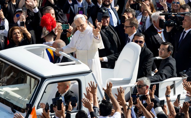 Pope Leo XIV waves to the crowds as he arrives for his installation Mass in St. Peter's Square on Sunday, May 18, 2025, at the Vatican. (Brian Cassella/Chicago Tribune)