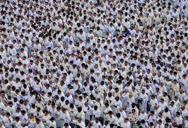 Members of the clergy pray as Pope Leo XIV is installed during Mass in St. Peter's Square on Sunday, May 18, 2025, at the Vatican. (Brian Cassella/Chicago Tribune)