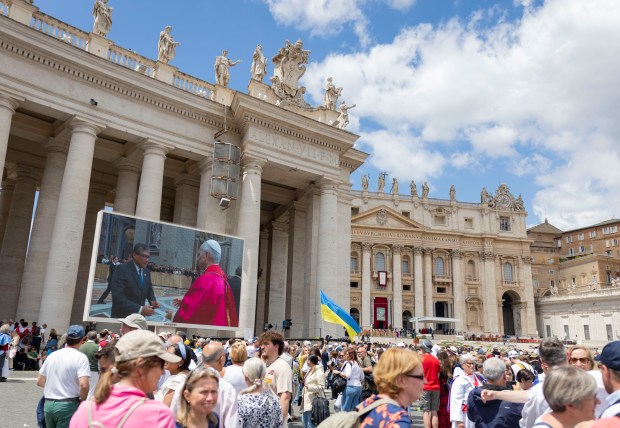 Pope Leo XIV continues to greet people inside the basilica as the crowd watches on screens after installation Mass in St. Peter's Square on Sunday, May 18, 2025, at the Vatican. (Brian Cassella/Chicago Tribune)