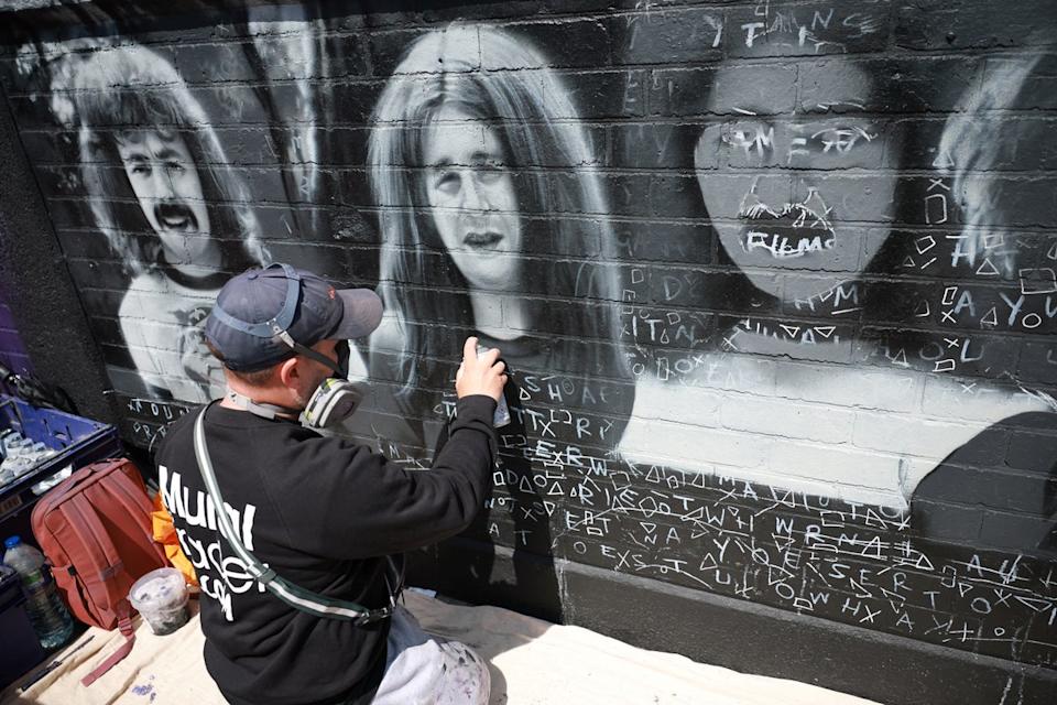 Artist Mr Murals prepares to work on his mural of rock band Black Sabbath ahead of their upcoming concert in Birmingham (REUTERS)