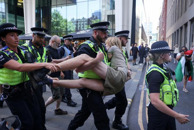 Police officers carry a detained demonstrator, during a protest calling for the de-proscription of the Palestine Action group, in Manchester, England, on July 12, 2025.