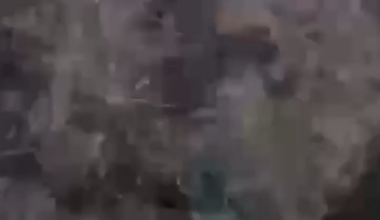 A Ukrainian UAV records how a Russian soldier, after their position was hit by a grenade, tries to push one of his injured comrades out of their dugout. First with his hands, later using his rifle to get him further away from the entrance of the position, even after he is injured again.