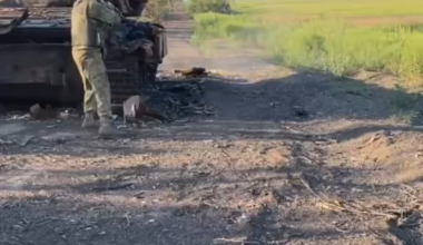 Russian soldier shoots at an anti-personnel mine to get rid of it somewhere in eastern Ukraine
