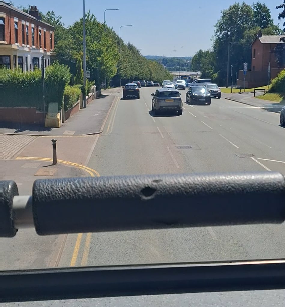 Front of the top of a double decker, cold can of irn bru, leaving Preston! Life's good!