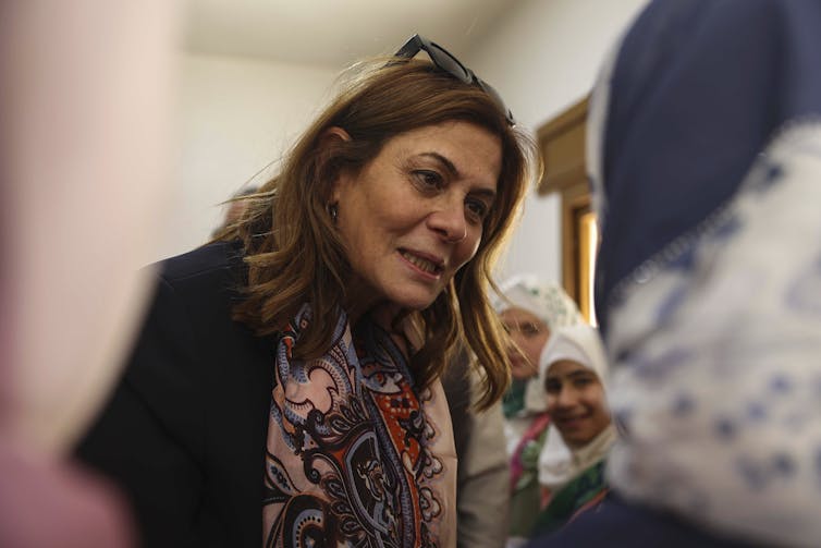 Syrian Minister of Social Affairs and Labor Hind Kabawat, speaks with children during her visit to Al-Yasamin orphanage